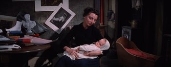 Movie still from “Lust for Life” (1956), directed by George Cukor – A woman holding a baby in her arms; Medium shot, High angle