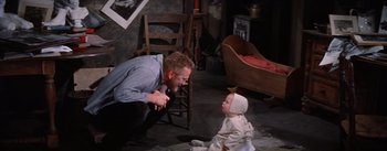 A man and a baby in a living room