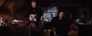 Movie still from “Lust for Life” (1956), directed by George Cukor – A man and a woman are sitting in a dark room; Medium shot, Low angle