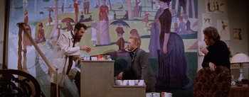 Movie still from “Lust for Life” (1956), directed by George Cukor – Two men standing in front of a table with cups on top of it; Medium shot, Low angle