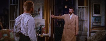 Movie still from “Lust for Life” (1956), directed by George Cukor – A man wearing a trench coat and a white dress shirt; Medium shot, Over the shoulder angle
