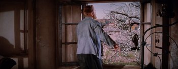 Movie still from “Lust for Life” (1956), directed by George Cukor – A man standing in front of an open window; Medium shot, Low angle
