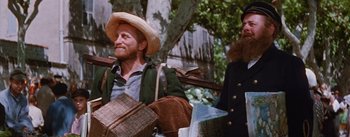 Movie still from “Lust for Life” (1956), directed by George Cukor – A man wearing a straw hat sitting next to a woman; Medium shot, Low angle