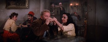 Movie still from “Lust for Life” (1956), directed by George Cukor – A man and a woman sitting at a table; Medium shot, High angle