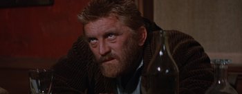 Movie still from “Lust for Life” (1956), directed by George Cukor – A person sitting at a table with a glass of wine; Close Up shot, Low angle