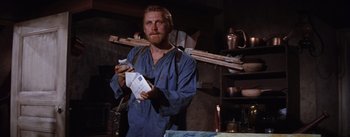 Movie still from “Lust for Life” (1956), directed by George Cukor – A man holding a piece of paper in his hands; Medium shot, Low angle