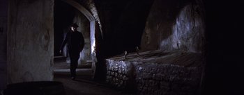 Movie still from “Lust for Life” (1956), directed by George Cukor – A man standing next to a pile of bales of hay; Wide shot, High angle