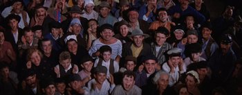 Movie still from “Lust for Life” (1956), directed by George Cukor – A large group of people wearing hats and smiling for the camera; Medium shot, High angle