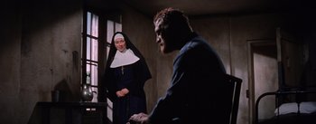 Movie still from “Lust for Life” (1956), directed by George Cukor – A woman in a nun's outfit and a man in a blue shirt; Medium shot, High angle