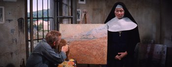 Movie still from “Lust for Life” (1956), directed by George Cukor – A man and a woman are painting a picture; Medium shot, Low angle