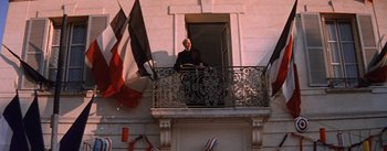Movie still from “Lust for Life” (1956), directed by George Cukor – A man standing on the balcony of a building; Wide shot, Low angle