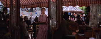 Movie still from “Lust for Life” (1956), directed by George Cukor – A woman holding a tray of food at a restaurant; Medium shot, Over the shoulder angle