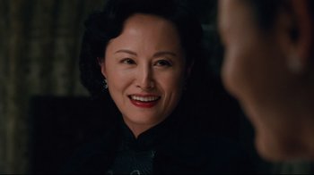 Movie still from “Lust, Caution” (2007), directed by Ang Lee – A woman with dark hair smiles at the camera; Close Up shot, Over the shoulder angle