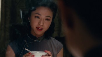 Movie still from “Lust, Caution” (2007), directed by Ang Lee – A young woman holding a bowl in front of a mirror; Close Up shot, Over the shoulder angle