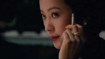 Movie still from “Lust, Caution” (2007), directed by Ang Lee – A woman holding a cell phone up to her ear; Close Up shot, High angle