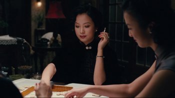Movie still from “Lust, Caution” (2007), directed by Ang Lee – Two women are sitting at a table and one of the women is holding a pen; Medium shot, Over the shoulder angle