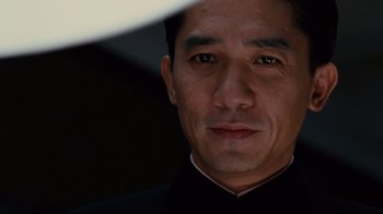 Movie still from “Lust, Caution” (2007), directed by Ang Lee – A person wearing a suit and tie; Close Up shot, Low angle