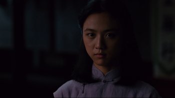 Movie still from “Lust, Caution” (2007), directed by Ang Lee – A woman in a purple shirt is looking at the camera; Close Up shot, Low angle