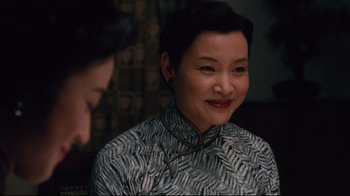 Movie still from “Lust, Caution” (2007), directed by Ang Lee – A woman with short black hair is smiling at the camera; Close Up shot, Over the shoulder angle