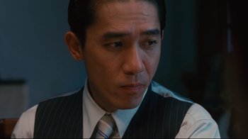 Movie still from “Lust, Caution” (2007), directed by Ang Lee – A person wearing a suit and tie; Close Up shot, Low angle