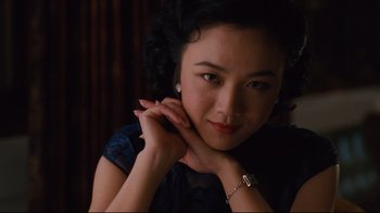 Movie still from “Lust, Caution” (2007), directed by Ang Lee – A beautiful young lady posing for a picture; Close Up shot, Over the shoulder angle