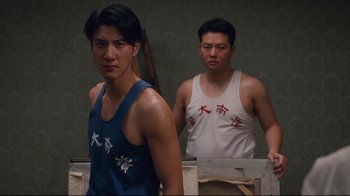 Movie still from “Lust, Caution” (2007), directed by Ang Lee – Two asian men standing next to each other in front of a wall; Medium shot, Low angle