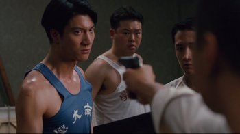 Movie still from “Lust, Caution” (2007), directed by Ang Lee – A group of young men standing next to each other in a room; Medium shot, Over the shoulder angle