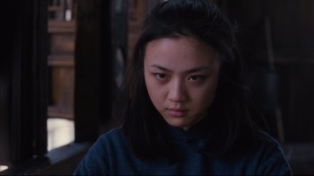 Movie still from “Lust, Caution” (2007), directed by Ang Lee – A woman with long black hair is looking at the camera; Close Up shot, Low angle