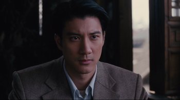 Movie still from “Lust, Caution” (2007), directed by Ang Lee – A person wearing a suit and tie; Close Up shot, High angle