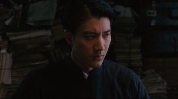 Movie still from “Lust, Caution” (2007), directed by Ang Lee – A man in a black shirt is looking to his left; Close Up shot, Over the shoulder angle