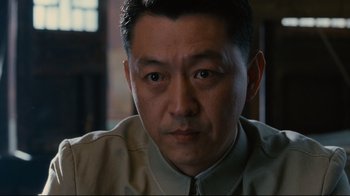 Movie still from “Lust, Caution” (2007), directed by Ang Lee – A person wearing a shirt and tie; Close Up shot, Low angle