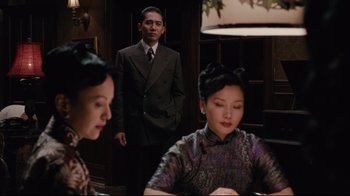 Movie still from “Lust, Caution” (2007), directed by Ang Lee – A man and two women in a room; Medium shot, Over the shoulder angle