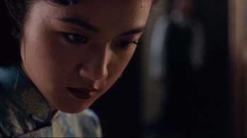 Movie still from “Lust, Caution” (2007), directed by Ang Lee – A woman's face in the dark; Close Up shot, Over the shoulder angle