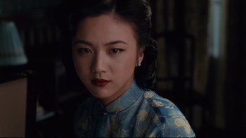 Movie still from “Lust, Caution” (2007), directed by Ang Lee – A woman in a cheongsam is looking at the camera; Close Up shot, Over the shoulder angle
