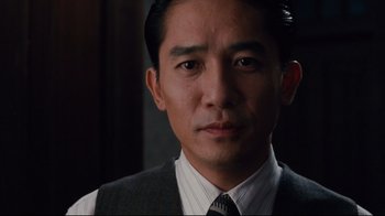 Movie still from “Lust, Caution” (2007), directed by Ang Lee – A person wearing a suit and tie; Close Up shot, Low angle