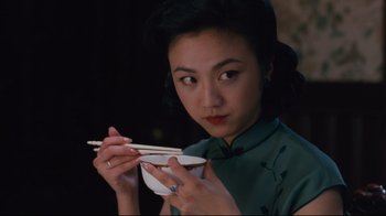 Movie still from “Lust, Caution” (2007), directed by Ang Lee – A woman holding chopsticks while holding a bowl of food; Close Up shot, High angle