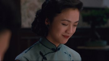 Movie still from “Lust, Caution” (2007), directed by Ang Lee – A woman in a blue dress is looking down; Close Up shot, Low angle