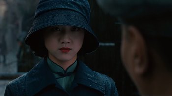 Movie still from “Lust, Caution” (2007), directed by Ang Lee – A young woman wearing a hat and a coat; Close Up shot, Over the shoulder angle