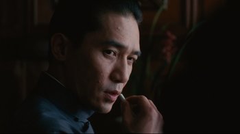 Movie still from “Lust, Caution” (2007), directed by Ang Lee – A person wearing a suit and tie; Close Up shot, Over the shoulder angle