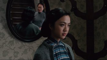 Movie still from “Lust, Caution” (2007), directed by Ang Lee – A young woman standing in front of a mirror; Medium shot, Over the shoulder angle