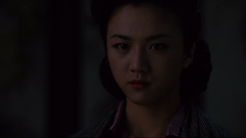 Movie still from “Lust, Caution” (2007), directed by Ang Lee – A young woman with dark hair wearing a pink shirt; Close Up shot, Over the shoulder angle
