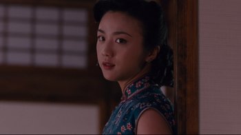 Movie still from “Lust, Caution” (2007), directed by Ang Lee – A woman in a blue dress is standing by a wall; Close Up shot, Low angle
