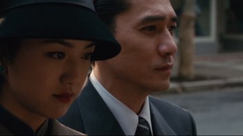 Movie still from “Lust, Caution” (2007), directed by Ang Lee – A man and a woman wearing suits and a hat; Close Up shot, Low angle