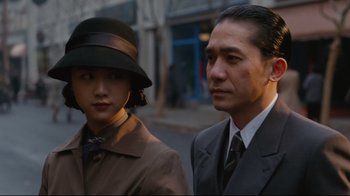 Movie still from “Lust, Caution” (2007), directed by Ang Lee – A man and a woman standing next to each other on the street; Close Up shot, Low angle