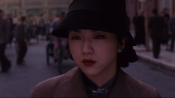 Movie still from “Lust, Caution” (2007), directed by Ang Lee – A woman wearing a black hat and a brown coat; Close Up shot, High angle