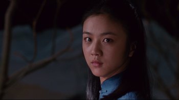 Movie still from “Lust, Caution” (2007), directed by Ang Lee – A young asian woman with long black hair wearing a blue shirt; Close Up shot, Low angle