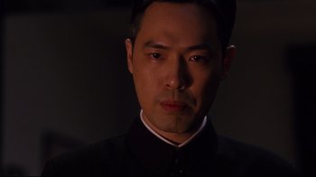 Movie still from “Lust, Caution” (2007), directed by Ang Lee – A person wearing a suit and tie; Close Up shot, Low angle