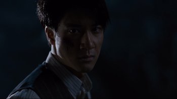 Movie still from “Lust, Caution” (2007), directed by Ang Lee – A person wearing a suit and tie; Close Up shot, Low angle