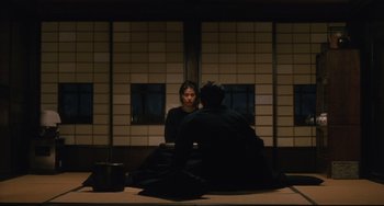 Movie still from “Maborosi” (1995), directed by Kore-eda Hirokazu – A man and a woman sitting in front of each other; Wide shot, Over the shoulder angle