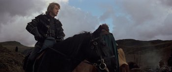 Movie still from “Macbeth” (1971), directed by Roman Polanski – A man riding on the back of a black horse; Medium shot, Low angle